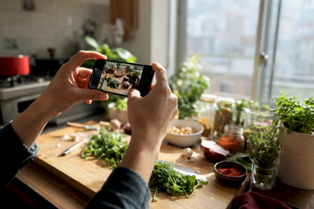 Hands photographing kitchen counter during recipe