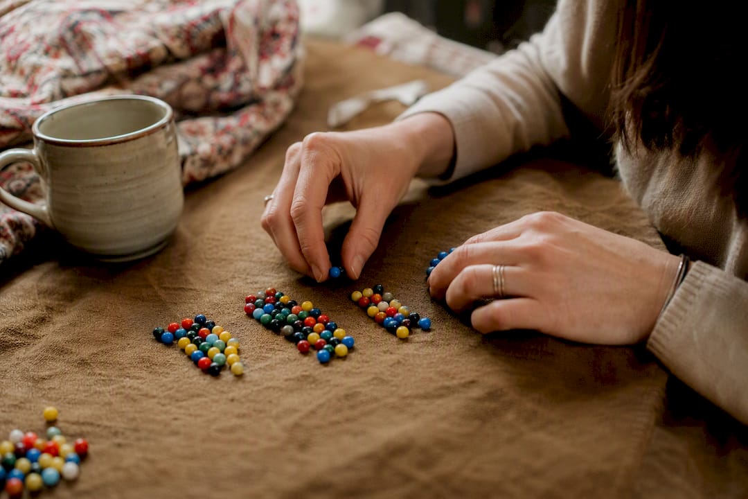 Hands manipulating symbolic data beads for bootstrap