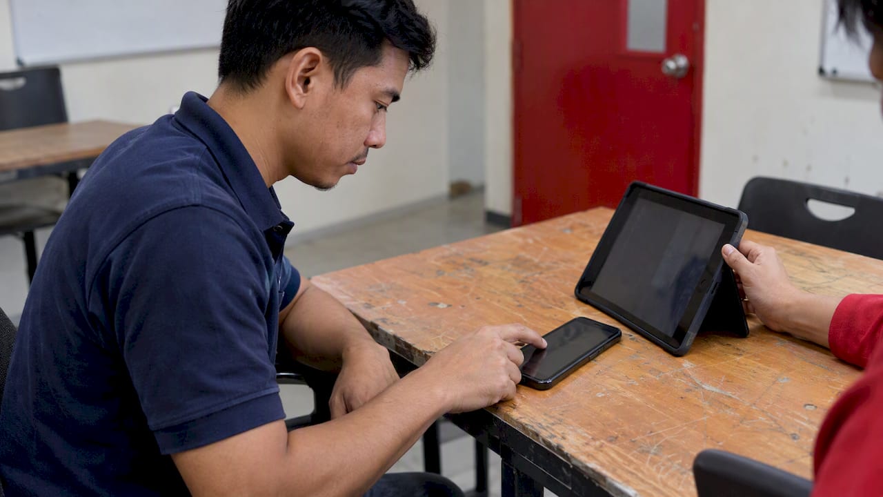 Enumerator testing survey on tablet and phone